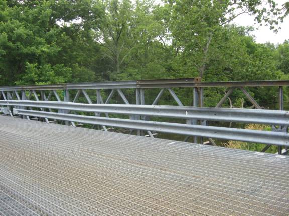 An iron bridge on DeKay Road crosses a bubbling creek.