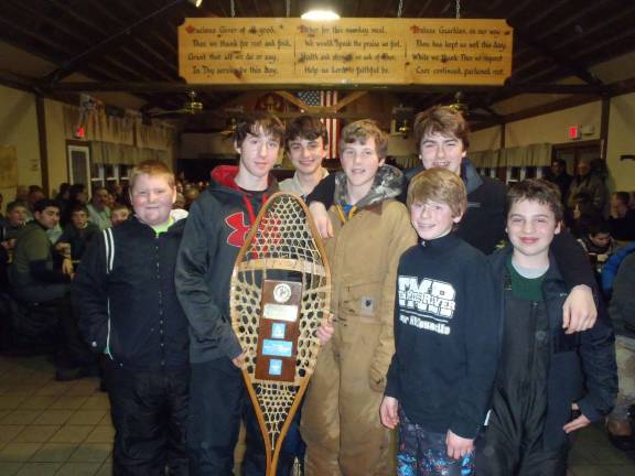 Troop 84 attends Klondike Derby The first-place sled team recieves its trophy.
