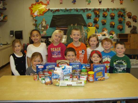 Food drive sends good message home for kids Deb Puskas kindergarten students are shown with food donated for the food drive.