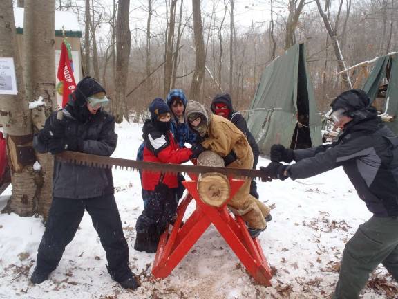 Troop 84 attends Klondike Derby Boy Scouts demonstrate teamwork with a two-man saw.