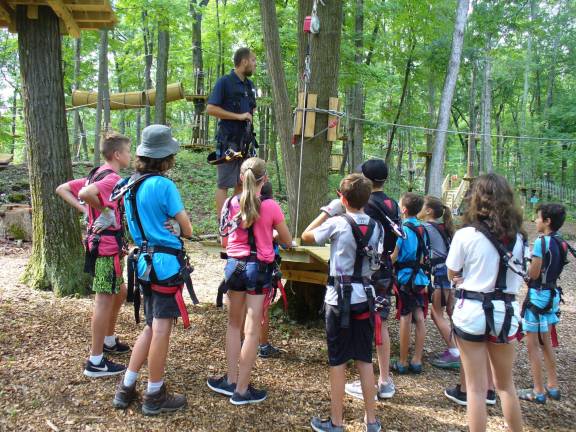 Day campers receive last-minute instructions from staff member Bobby Blair.