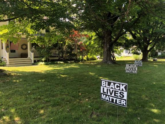 Residents see ‘coded racism’ in firehouse sign Black Lives Matter signs in a yard on Forester Avenue.