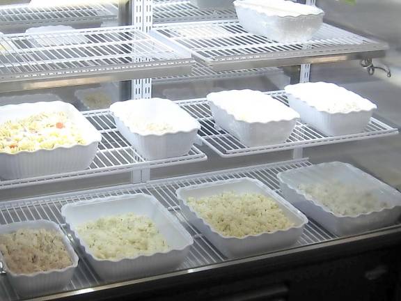 Homemade salads line the fridge at the Bites and Grill Deli.