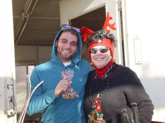 The chair lift operator on the top of the Sugar Slope at Mountain Creek is happy to receive his gift of Christmas cookies.