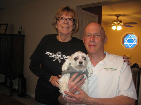 PHOTOS BY JANET REDYKE Nancy and Mark Wolfe of Supplies for Soldiers and their dog Princess hope a fair postal rate resolution will continue to bring our soldiers items they need.