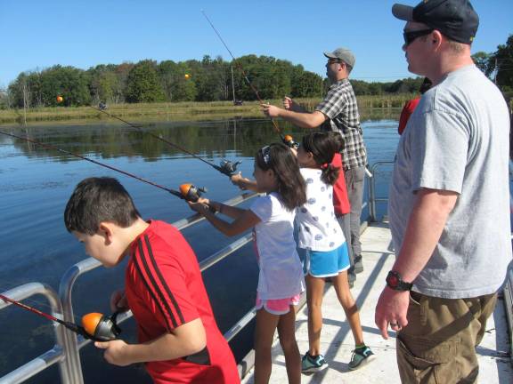 Kids have a ball fishing on a beautiful day.