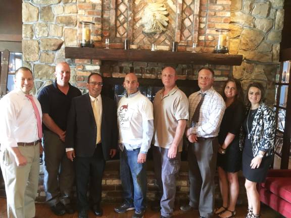 Making arrangement for the event in the restaurant are, from left, First Hope Bank COO Dan Beatty, Andover Township Police Chief Eric Danielson, First Hope Bank President and CEO Donald Somma, Steve Scro, Byram Police Chief Peter Zabita, Sparta Police Lt. Neil Spidaletto, First Hope Bank Marketing Officer Lauren Blackburn and First Hope Bank Sparta Branch Manager Lidia Zdunek.