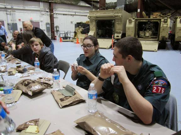 Crew Historian Melissa Sarcona and crew Treasurer Thomas Seltzer, eating military MRE lunches