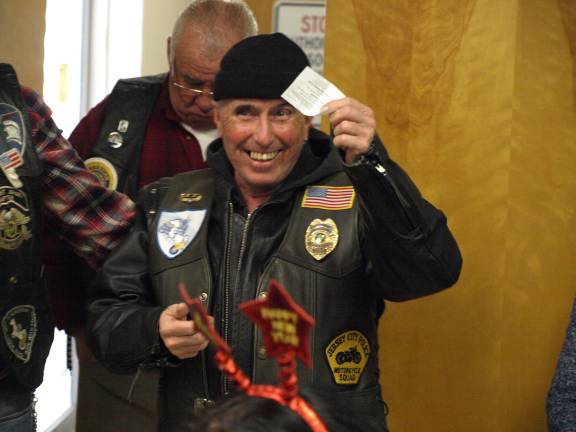 Van drives into motorcyclists The 50/50 raffle winner Al Metz of Sandyston Township had the honor of picking the Harley-Davidson raffle ticket.
