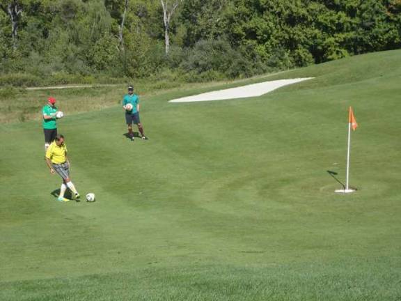 A footgolfer attempts a long-range putt.