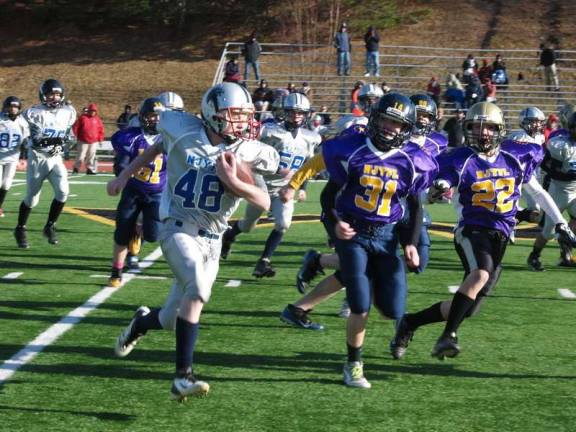 Youth football all-star games played Silver running back Justin Lisinsky (48) on the move with Purple defenders in hot pursuit in the pee wee game.