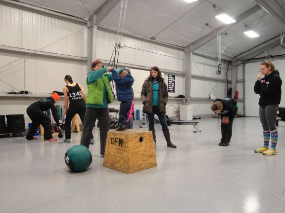 Sparta businesses band together for open house Photos by Scott Baker Guests try out the apparatus at Crossfit LMS at the fist-ever open house Jan. 25 in Sparta.