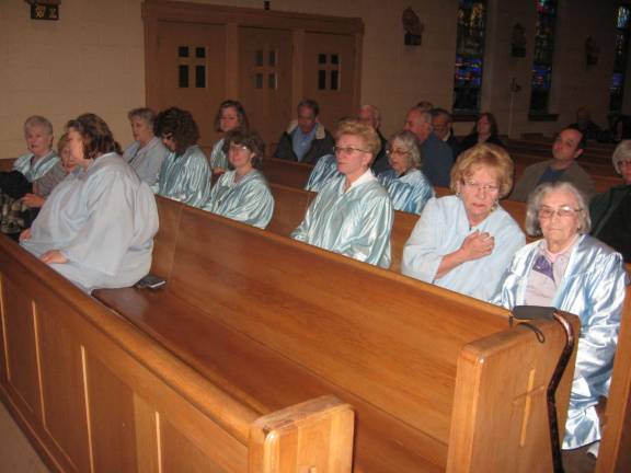 Blue-robed Rosary Society members await the beginning of the May 13 mass.