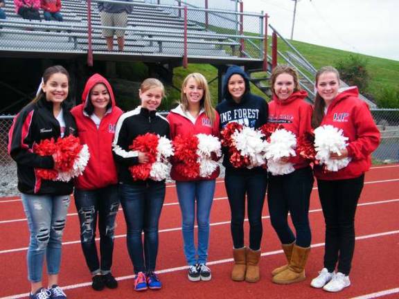 High Point cheerleading squad, coached this year by Guidance Counselor Maggie Meyer, preparing to cheer on their fellow students.