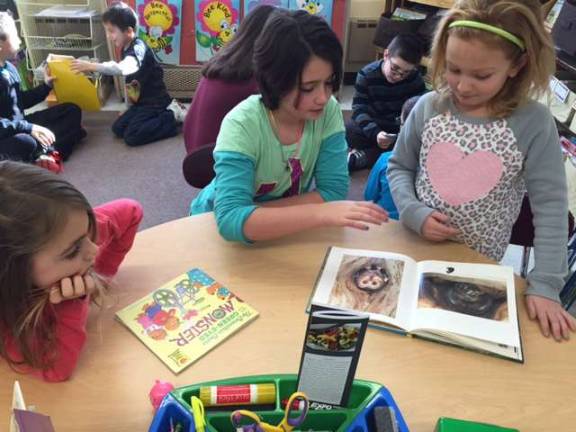 Ogdensburg students complete 2,500 acts of kindess Mrs. Mongon's fifth-grade classe visited the first-grade classrooms to read their descriptive Native American travel brochures with their reading buddies. The first-graders also shared their books with the fifth-graders to meet the "reading to a younger child" act of kindness.