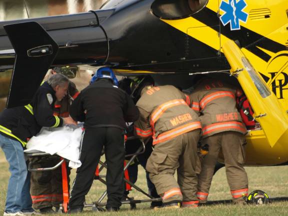 Van drives into motorcyclists Ogdensburg First Aid and Fire Department members assist the aircrew in loading the victim for a flight to Morristown Hospital.