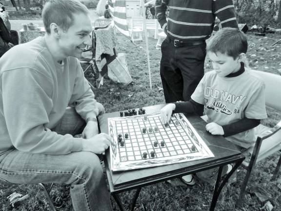Honoring the Vikings Evan Casaleggio, 8, of Stockholm, thinks about his next move during a game of Hnefatafl with his father, John.