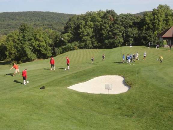 Competitors stretch and warm up before the first scored round of the tournament.