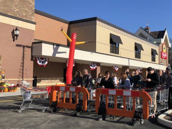 Shoppers wait for the end of the grand-opening ceremony. (Photo by Kathy Shwiff)