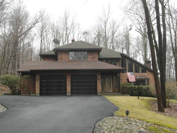 Contemporary colonial sits on parklike setting Contemporary colonial sits on parklike setting