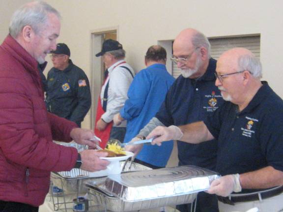 PHOTOS BY JANET REDYKE Members of the Knights of Columbus of St. Francis de Sales Church serve up a delicious Super Bowl Sunday pancake breakfast.
