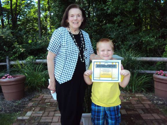 Holy Counselor Church holds contest for kids Conest winner Clayton Duryea is shown with Carolyn Bonstra.