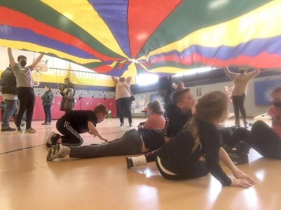 Students chill with friends at Cedar Mountain’s ‘Winter Wonderland’ Parachute games! (Photo provided)