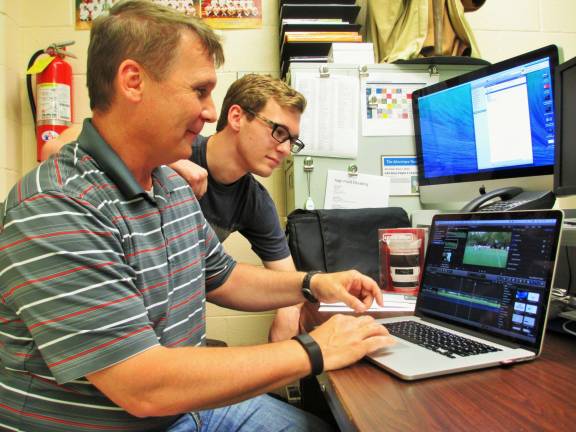 Photos by Viktoria-Leigh Wagner High Point Regional High School Technology Instructor Kevin Fenlon tutors his son and pupil, Garrett, Fenlon, on the inner workings of video editing.