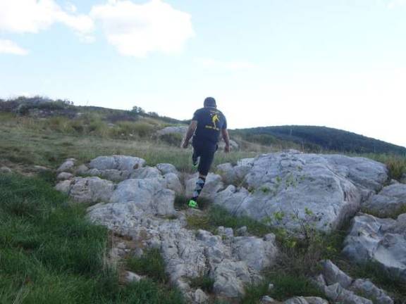 A member of Team Mexico kicks out of a rock hazard to avoid a penalty.