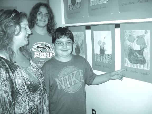 Paper Sculptures take center stage at Family Art Night Christopher Schnabel with his watercolor painting.