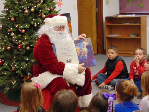 Santa reading &quot;T'was the Night before Christmas.&quot;