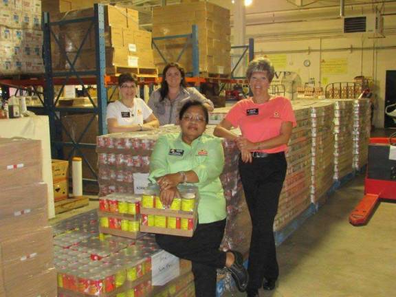 Photo provided Pictured from left: (back) Cathie Miller (Consumer Affairs Coordinator) and Allison Wefer (Communications Assistant). (front) Beverly Ruddock (Customer Service Manager at ShopRite of Succasunna), and Cherie Hudson (Customer Service Manager in Franklin) pose next to some of the donated pallets at NORWESCAP.