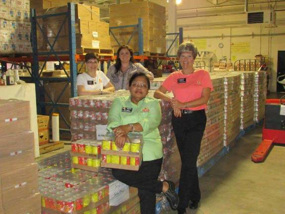 Hunger doesn't take a vacation Photo provided Pictured from left: (back) Cathie Miller (Consumer Affairs Coordinator) and Allison Wefer (Communications Assistant). (front) Beverly Ruddock (Customer Service Manager at ShopRite of Succasunna), and Cherie Hudson (Customer Service Manager in Franklin) pose next to some of the donated pallets at NORWESCAP.