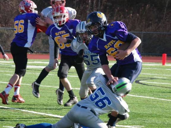 Youth football all-star games played The Silvers defensive lineman Rudy Lepara (56) stops Purple running back Zack Biango in the back field in the pee wee game.
