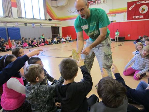 Animal expert Dominic Rizzo is shown having fun with the students and one of his reptile friends!