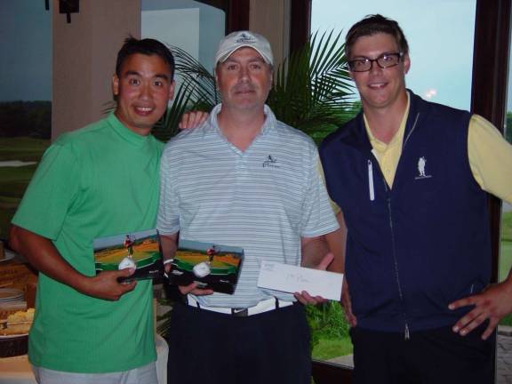 The best team of the day, Kevin Chiang and Demetrio Cutri with a 74, receives their prize from Event Coordinator Brian Riley