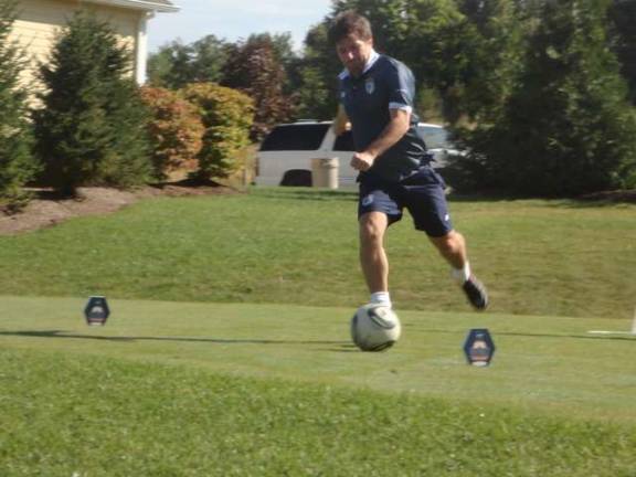 Photos by Scott Baker A member of Team Argentina kicks off on the first hole.