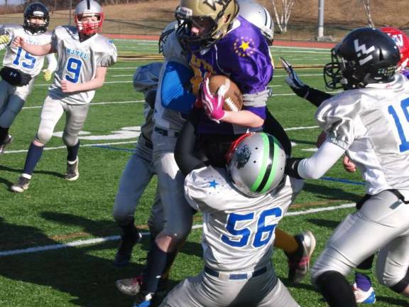 Youth football all-star games played The Silver defense converge on Purple running back Trevor Fleet in the pee wee game.
