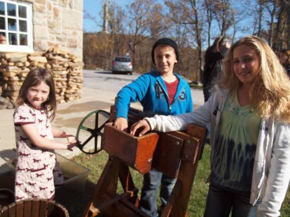 Friends of High Point host hearth cooking day Five year old Madeline Norwood, Luke White (10) and his sister Kaitlyn (12) work an antique apple press. The three are from Wantage, N.J. The Friends of High Point State Park hosted their annual Open Hearth Cooking Day on Saturday, October 26, 2013. The event took place inside the Interpretive Center. Cooking demonstrations featuring a variety of foods were available to visitors to sample.