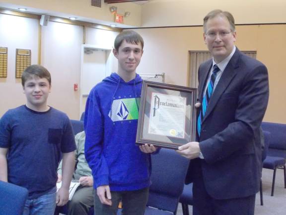 Photo by Vera Olinski From left, Tyler Shorr and Randy Shorr receive a proclamation from Mayor Bill Baechter, honoring Cub Scout Pack 84.