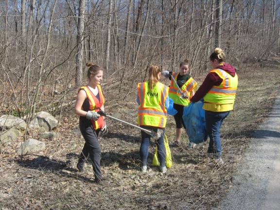 PHOTO BY JANET REDYKE Volunteers for Clean Communities, the youth group receives a donation that will be used for a summer trip to Connecticut where the group will repair and tidy up low income housing.Volunteers are Julia Gibbons, Jaclyn Lehman, Rebecca Annunziata and Laura Krone and are shown cleaning up litter accumulated on Canistear Road.