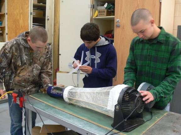 Young inventors take top prizes Luke Haggerty, Mike DeFalco and Mike Finocchiaro with their invention. Photo by Donna Puizina