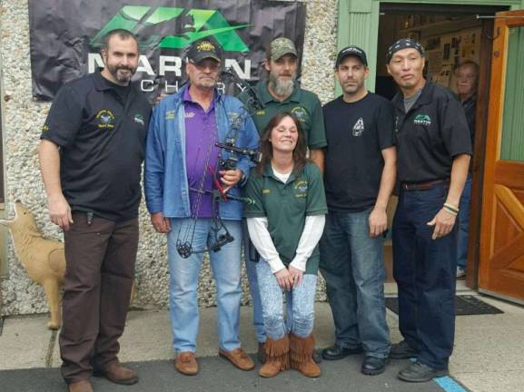 Veteran wounded warriors in action ceremony at Mountain Mike's. Veteran Bob Guidi recieved a Martin bow from Mountain Mike and his shooting team.