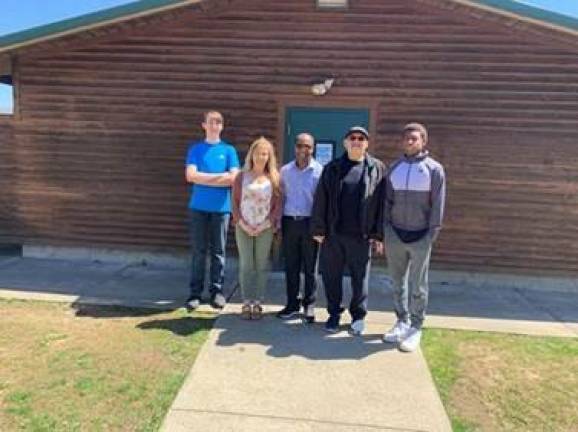 Director of Recreation, Mishelle Downtain with Pastor Edgir jean and members of the Men’s Ministry in front of the snackbar facility at Maple Grange Park.