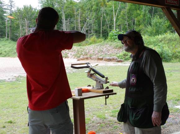 At right, nationally certified firearms instructor Larry McDermott of Livingston releases a clay pigeon for a visitor at the range.