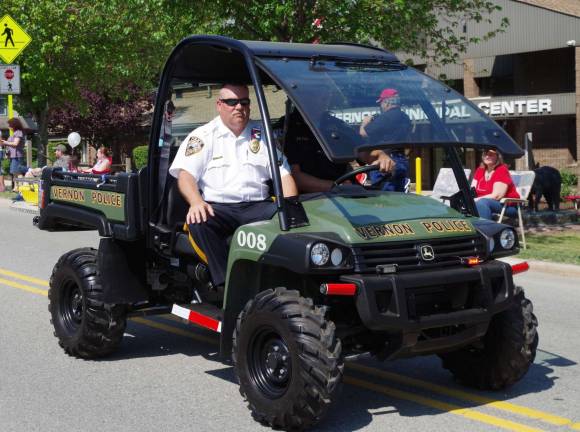 Near the front of the parade was Vernon Township Police Chief Randy Mills is shown in the department&#xfe;&#xc4;&#xf4;s John Deere Gator Ultimate Terrain Vehicle driven by Lt. Daniel Young.