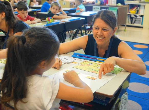 Cedar Mountain teachers honored Mary Ollert achieves learning with a student.
