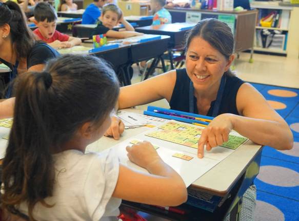 Mary Ollert achieves learning with a student.