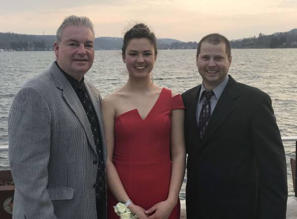 Maya Rokoczy is shown flanked by Coach Ferguson, left, and Coach Shenise (right).