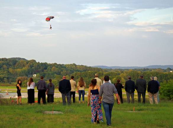 Some of the 70 guests who attended the Sussex Antlers tenth anniversary gathering had the unique opportunity to enjoy a nearly eyelevel parachuting show as these tandem ski divers prepared to land in the fields at the Sussex Airport below.